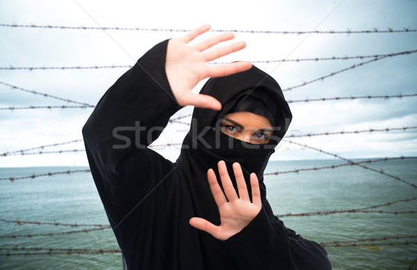 muslim woman in hijab making protective gesture Stock photo © dolgachov