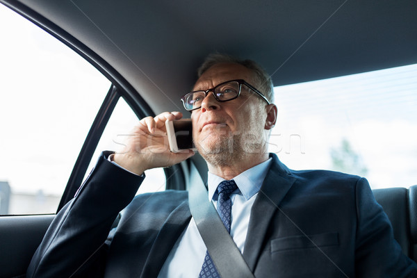 senior businessman calling on smartphone in car Stock photo © dolgachov
