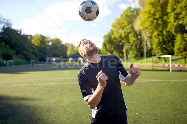 soccer player playing with ball on field Stock photo © dolgachov