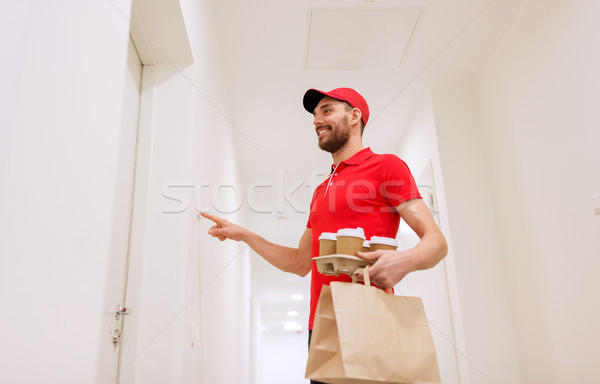 delivery man with coffee and food ringing doorbell Stock photo © dolgachov