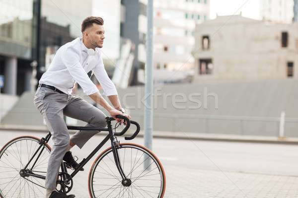 man with headphones riding bicycle on city street Stock photo © dolgachov