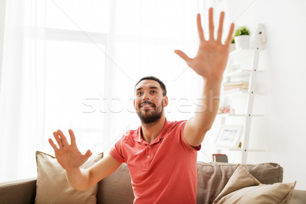 Szczęśliwy człowiek dotknąć coś wyimaginowany domu Zdjęcia stock © dolgachov
