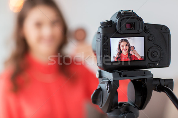 woman with bronzer and camera recording video Stock photo © dolgachov