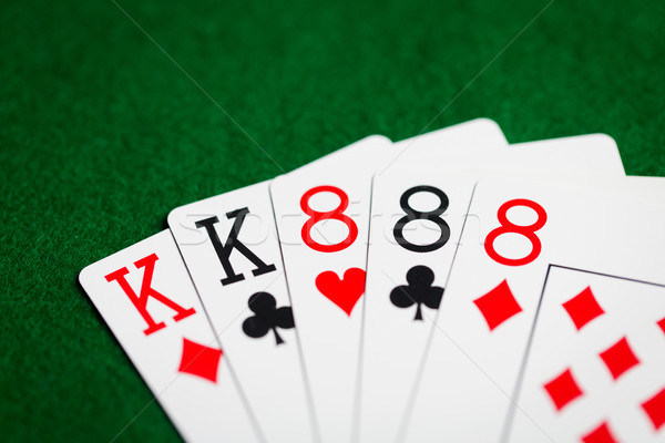 poker hand of playing cards on green casino cloth Stock photo © dolgachov