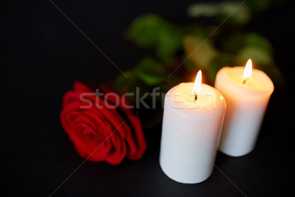 red rose and burning candles over black background Stock photo © dolgachov
