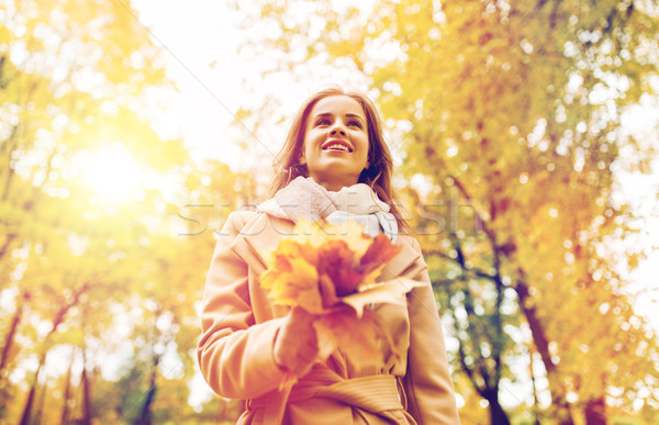 beautiful woman with maple leaves in autumn park Stock photo © dolgachov