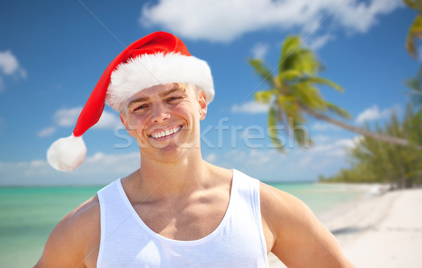 Glücklich junger Mann hat Strand Weihnachten Stock foto © dolgachov