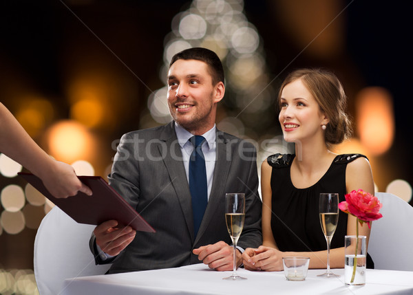 couple taking menu at christmas restaurant Stock photo © dolgachov