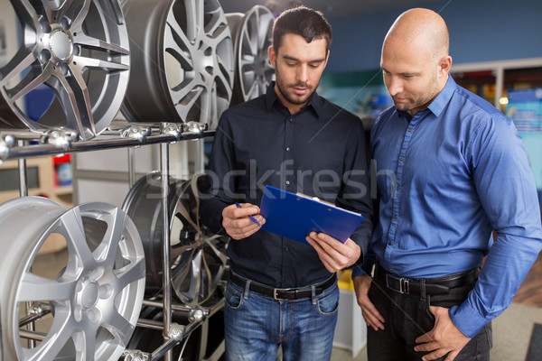 customer and salesman at car service or auto store Stock photo © dolgachov