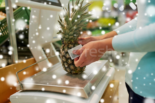 customer with pineapple on scale at grocery store Stock photo © dolgachov