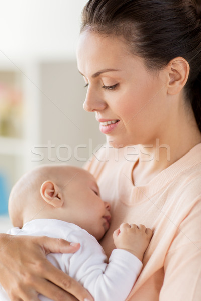 Stock photo: close up of mother holding sleeping baby