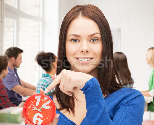 girl holding big clock at school Stock photo © dolgachov