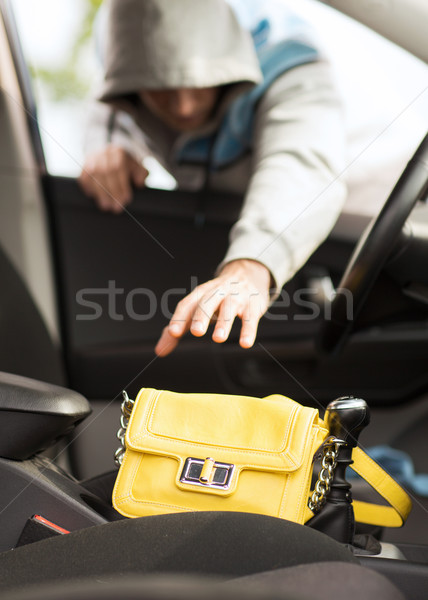 thief stealing bag from the car Stock photo © dolgachov