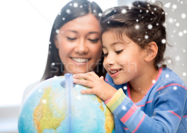 mother and daughter with globe Stock photo © dolgachov