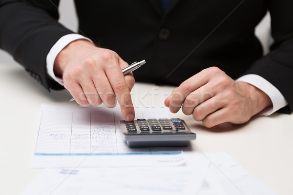 close up of businessman with papers and calculator Stock photo © dolgachov