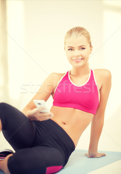 woman sitting on the floor with smartphone Stock photo © dolgachov