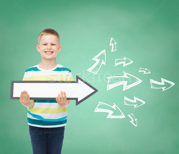 smiling little boy with blank arrow pointing right Stock photo © dolgachov