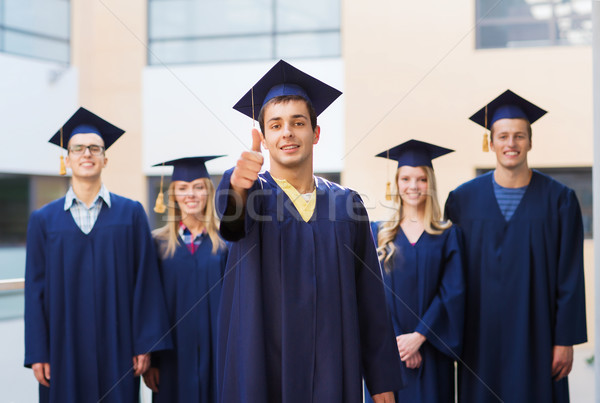 group of smiling students in mortarboards Stock photo © dolgachov