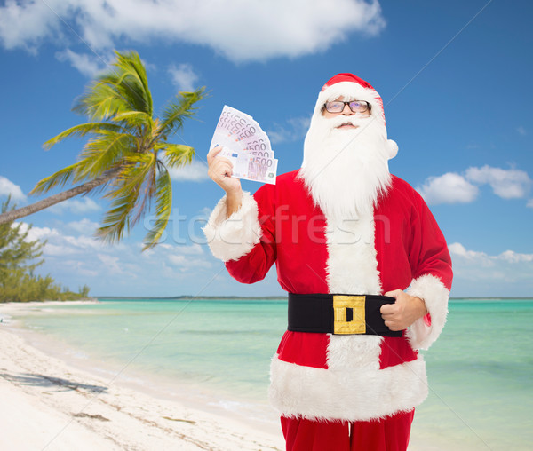 man in costume of santa claus with euro money Stock photo © dolgachov