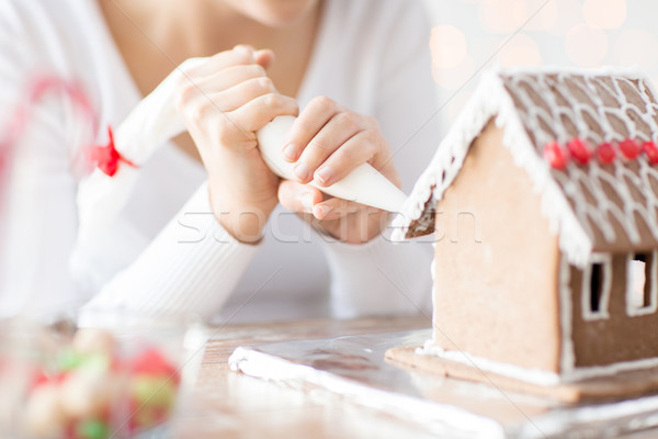 close up of woman making gingerbread house at home Stock photo © dolgachov