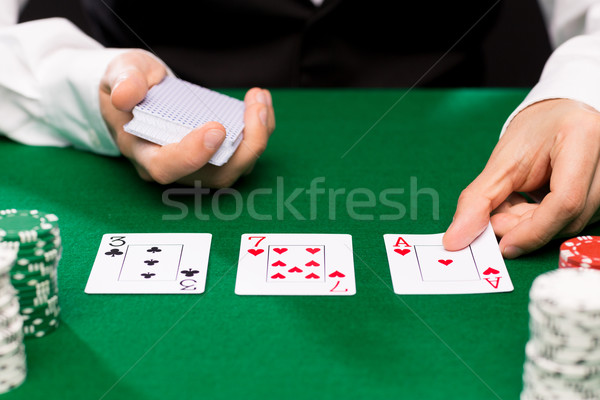 holdem dealer with playing cards and casino chips Stock photo © dolgachov
