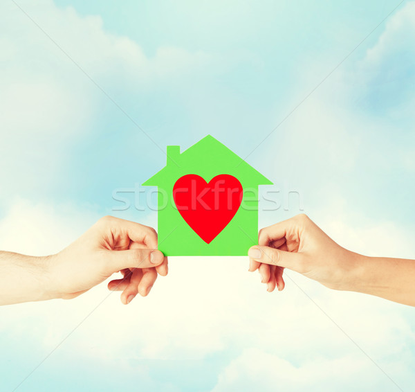couple hands holding green paper house Stock photo © dolgachov