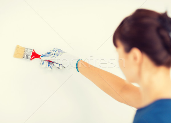 woman with paintbrush colouring the wall Stock photo © dolgachov