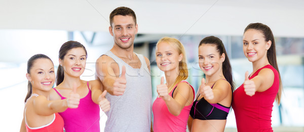 Stock photo: group of people in the gym showing thumbs up