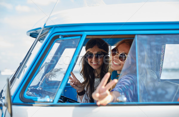 Stock photo: smiling young hippie women driving minivan car