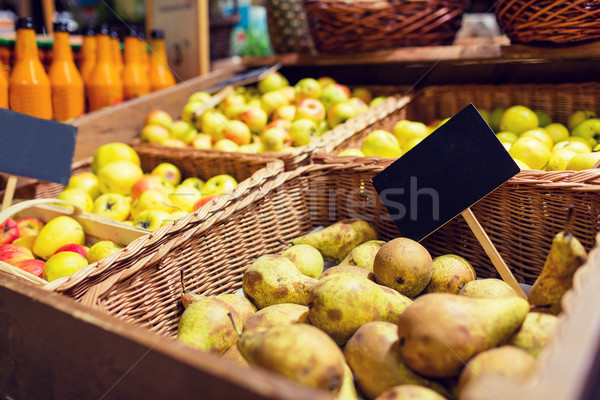 fruits in baskets with nameplates at food market Stock photo © dolgachov
