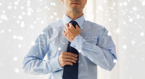 close up of man in shirt adjusting tie on neck Stock photo © dolgachov