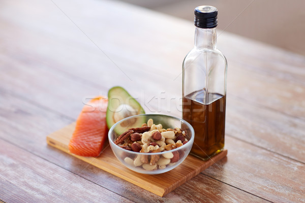 close up of food and olive oil bottle on table Stock photo © dolgachov