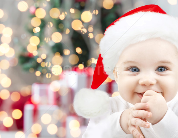 happy baby in santa hat over christmas lights Stock photo © dolgachov