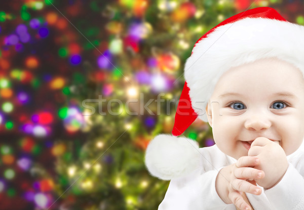 happy baby in santa hat over christmas lights Stock photo © dolgachov
