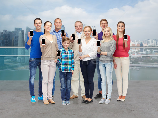 group of smiling people with smartphones Stock photo © dolgachov