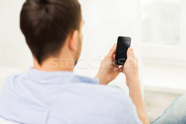 close up of man with smartphone at home Stock photo © dolgachov