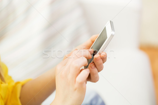 close up of hands texting on smartphone at home Stock photo © dolgachov
