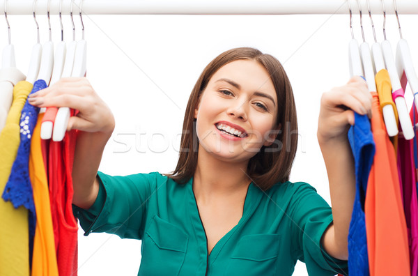 Stock photo: happy woman choosing clothes at home wardrobe