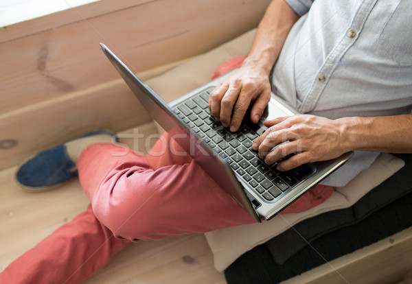 close up of creative man with laptop at office Stock photo © dolgachov