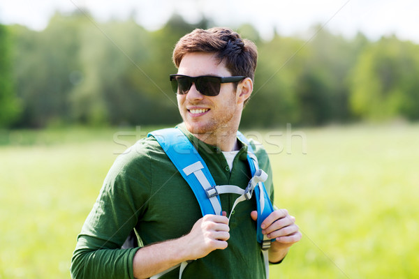 happy young man with backpack hiking outdoors Stock photo © dolgachov