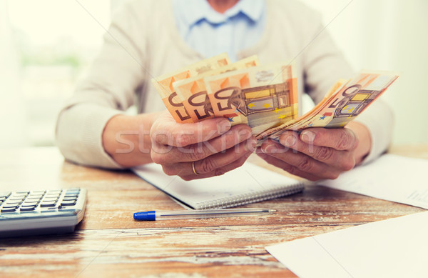 close up of senior woman counting money at home Stock photo © dolgachov