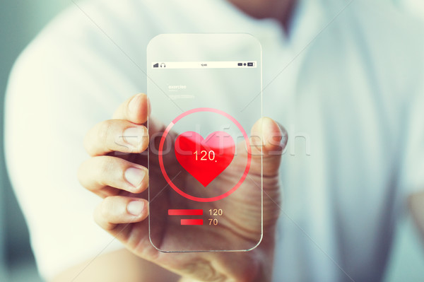 close up of hand with heart rate on smartphone Stock photo © dolgachov