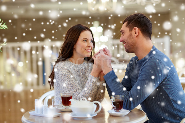 happy couple with tea holding hands at restaurant Stock photo © dolgachov