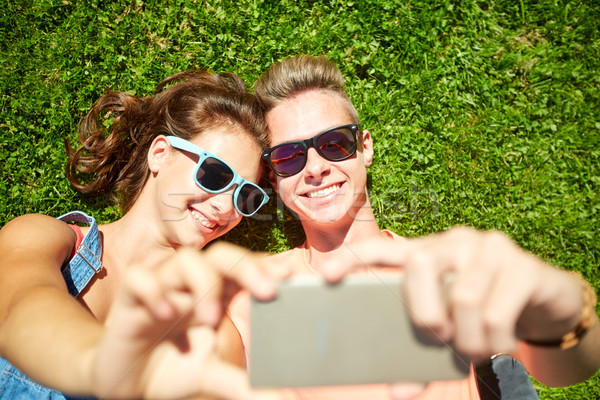 happy couple taking selfie on smartphone at summer Stock photo © dolgachov