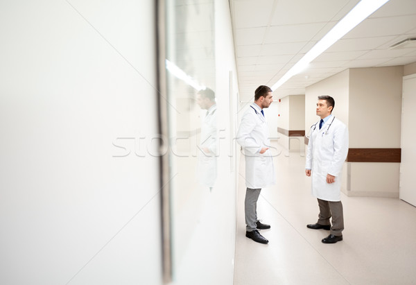 male doctors talking at hospital corridor Stock photo © dolgachov