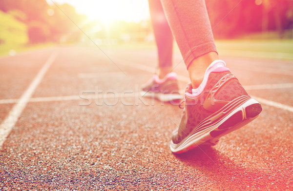 close up of woman feet running on track from back Stock photo © dolgachov