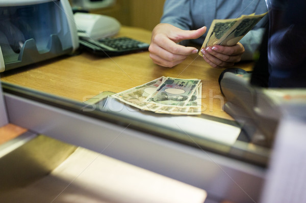 clerk counting cash money at bank office Stock photo © dolgachov