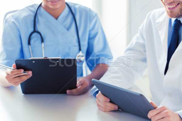 Stock photo: doctors with tablet pc and clipboard at hospital