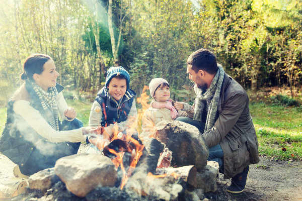 happy family roasting marshmallow over campfire Stock photo © dolgachov