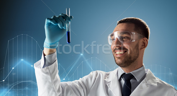 scientist in goggles with test tube and diagram Stock photo © dolgachov